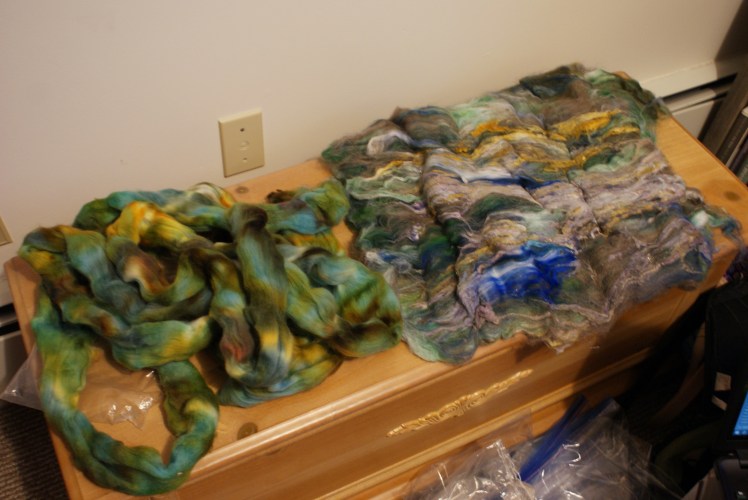 You can't see it in this picture, but the underside of the batt is a thick middle layer of kinda mermaid-colored faux cashmere and a bottom layer of a lot of hairy grey wool. 